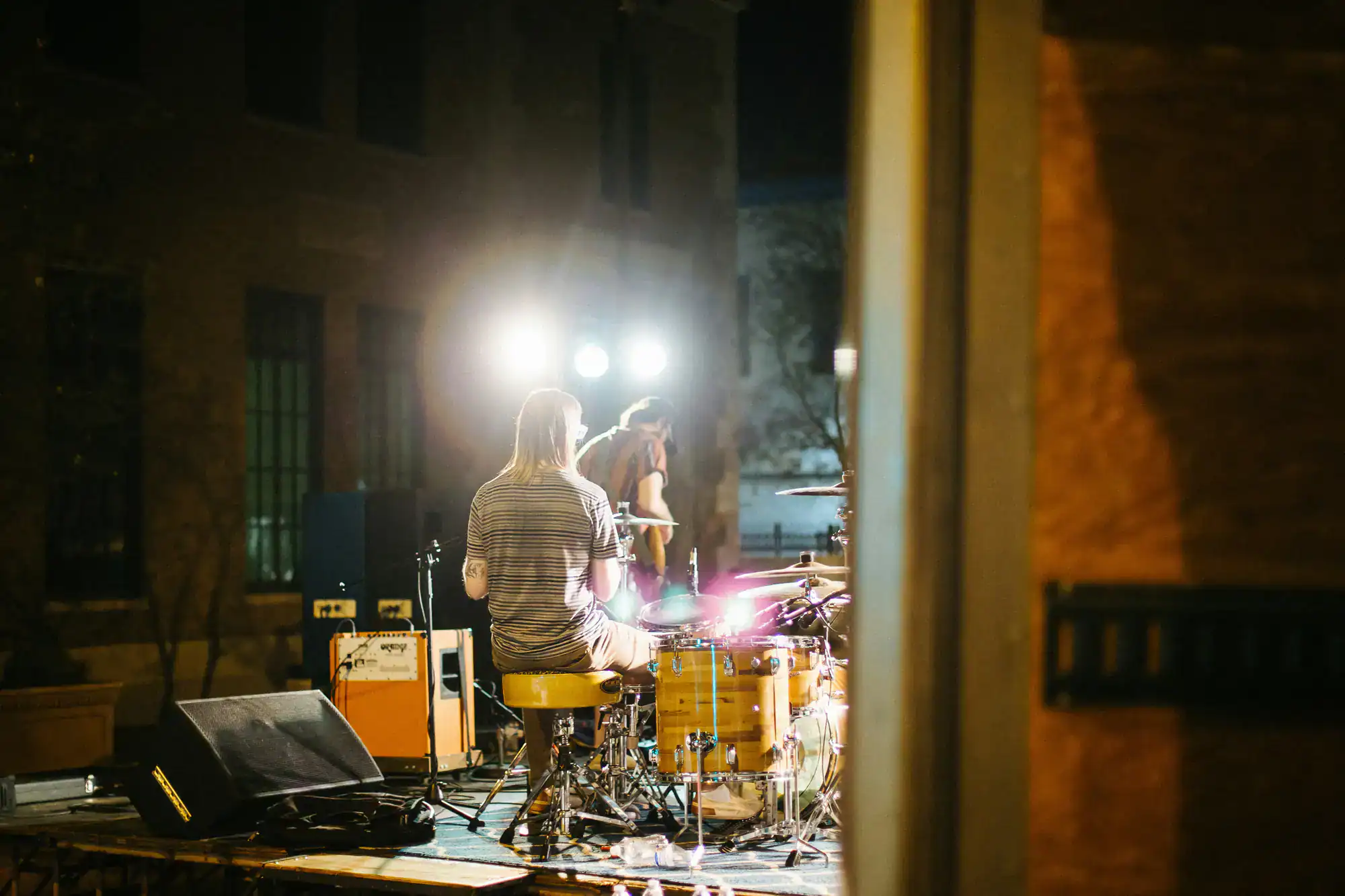 A wedding entertainment company band performs on an outdoor stage at night in Minnesota or Wisconsin.