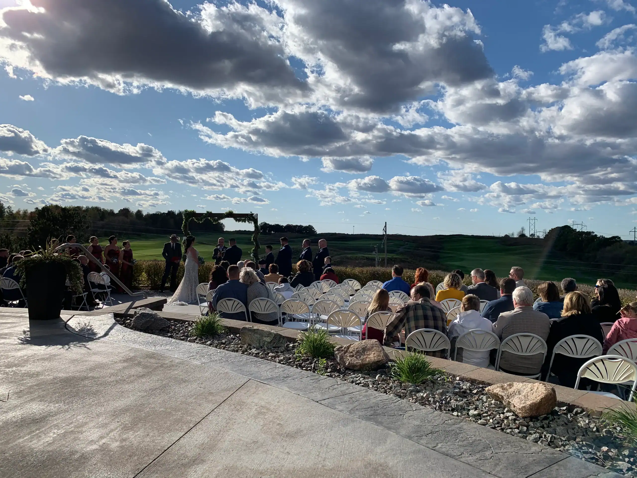 Outdoor wedding ceremony under clear, sunny skies, perfect setting for a wedding DJ Minnesota event.