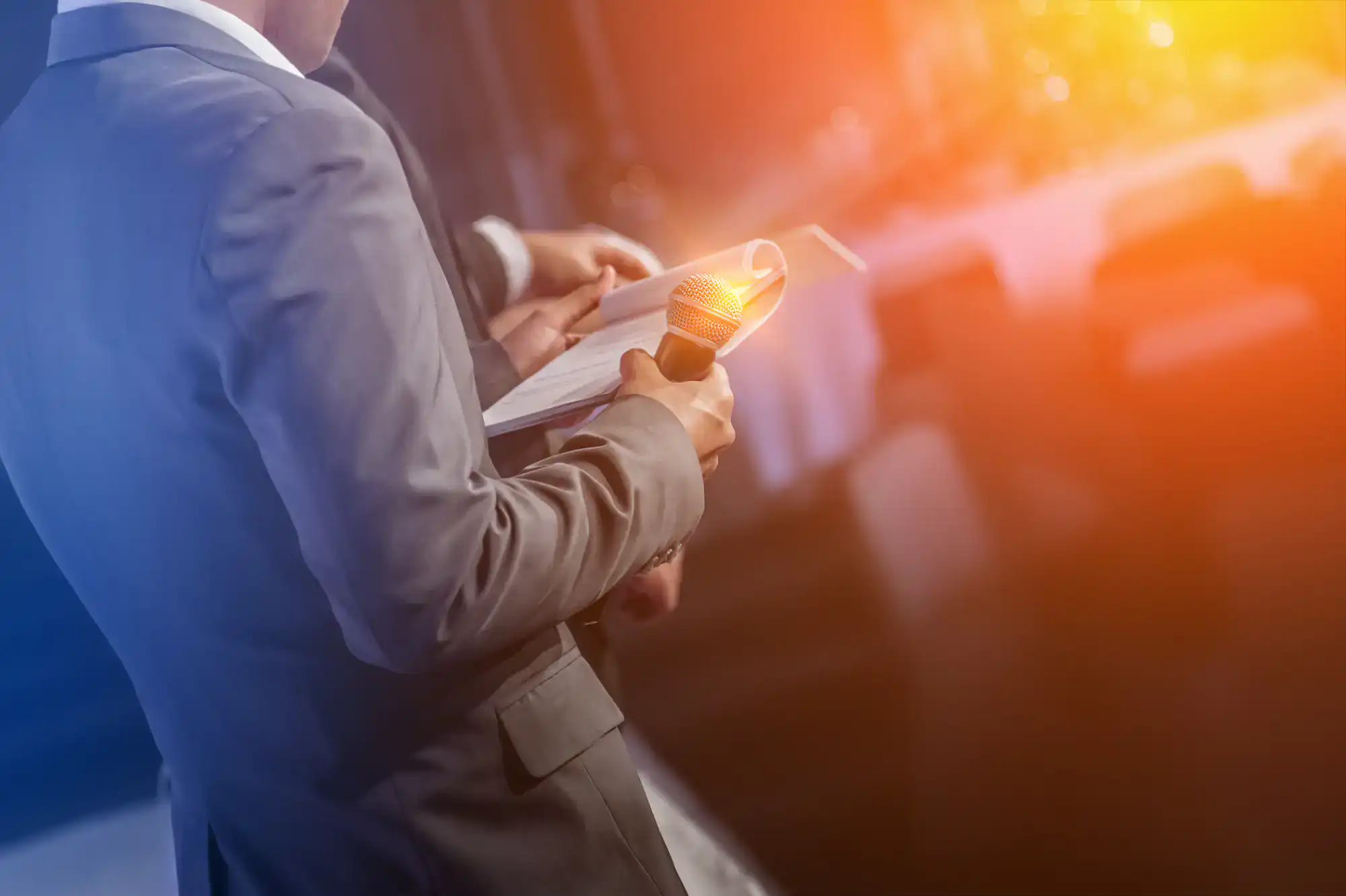 A man in a suit serves as MC, representing an expert wedding entertainment company in Minnesota.